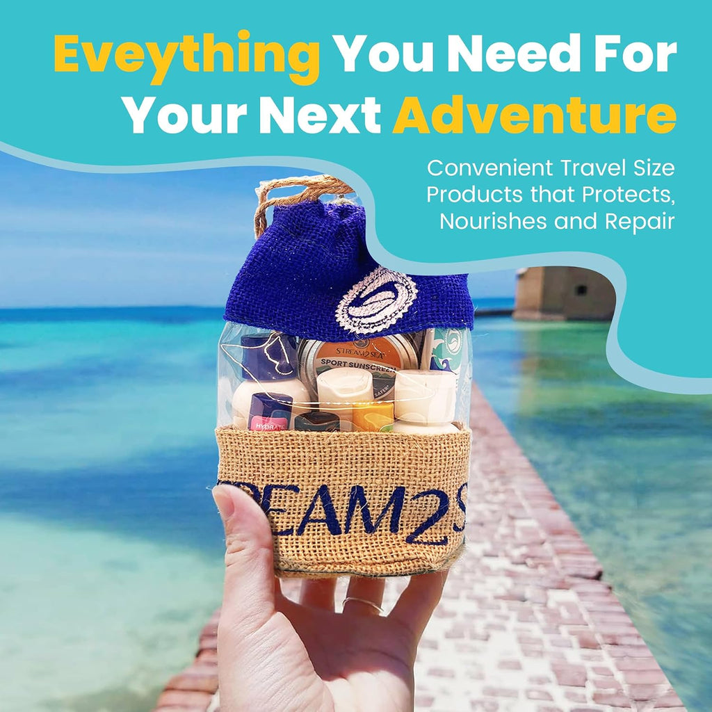 Hand holding a travel-sized product bag with a beach and ocean background. Stream2Sea Conscious Explorer Kit |Travel Size Dive & Water Sports Essentials